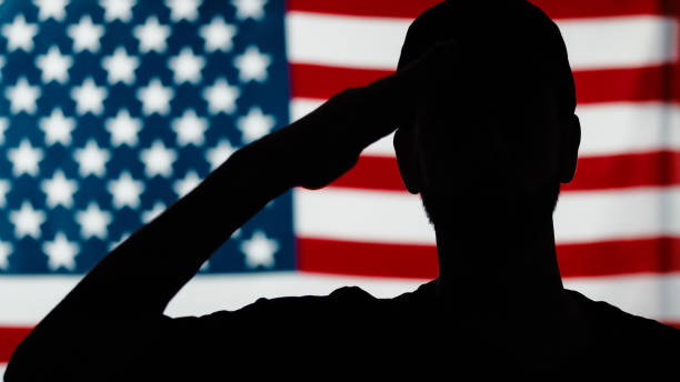 istock American veteran salutes. Close up silhouette 1398859801
