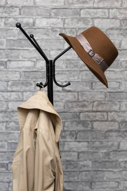 istock a hat and a raincoat hang on a metal floor hanger 1398860034