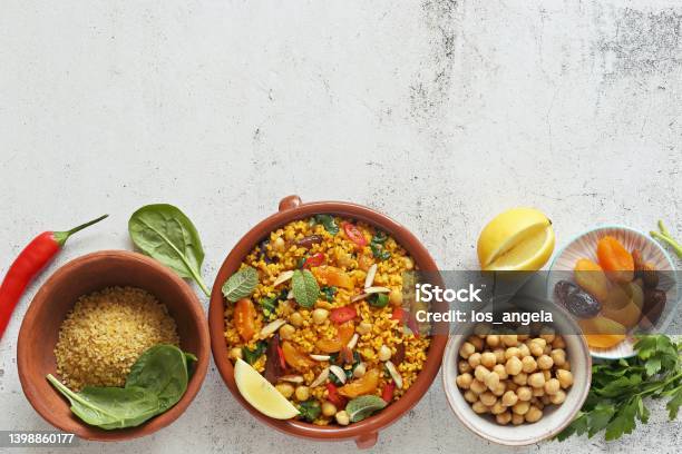 Vegan Moroccan Bulgur With Chick Peas Spinach Dried Apricots And Date Fruit Stock Photo - Download Image Now