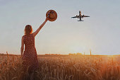 wanderlust travel concept, woman cheering airplane
