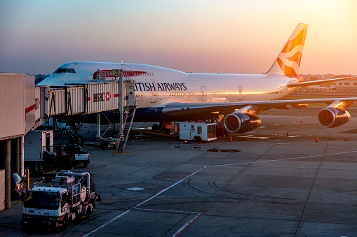 Heathrow Airport, London, England - JULY 28 2016: British Airways jet getting ready to load passengers at Europe's busiest airport at sunset.