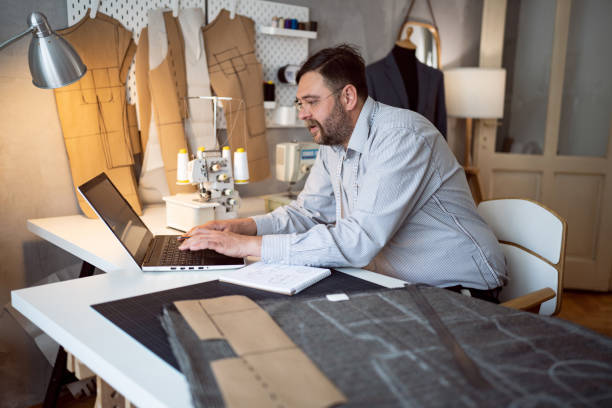 istock Mid-adult Caucasian male tailor working at his design studio 1398861100