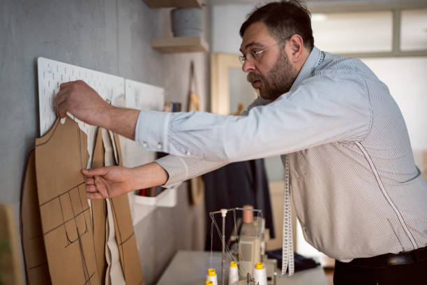 istock Mid-adult male tailor working at his design studio 1398861268