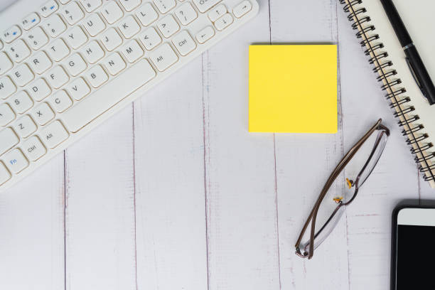 istock Directly above view of office desk table with adhesive note. Copy space. 1398861439