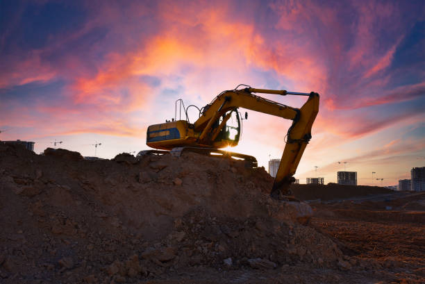 istock Excavator on earthmoving on sunset background. Loader at open pit mining. Excavator digs gravel in quarry. 1398863356