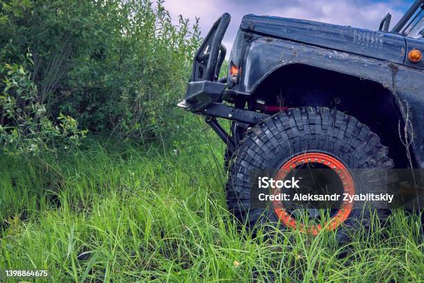 4x4 Offroad Car Overcomes An Obstacle Going Up The Hill Stock Photo - Download Image Now