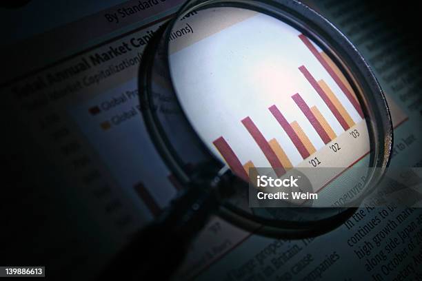 Magnifying Glass Enlarging A Graph Analyzing Business Stock Photo - Download Image Now