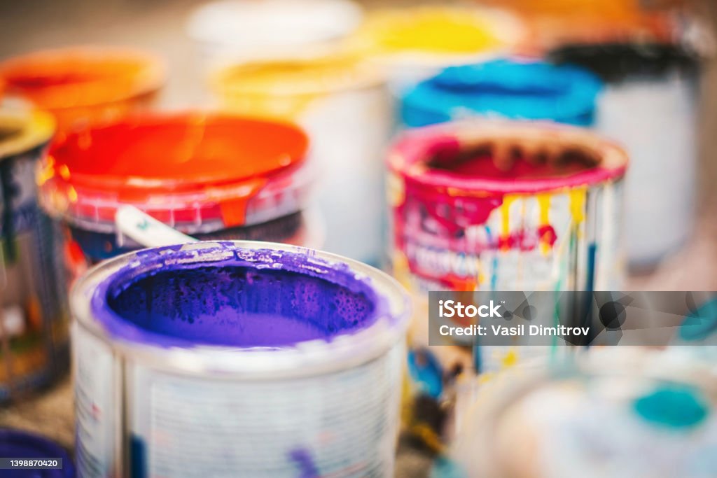 Opened paint cans with colors Opened paint cans with colors. Artistic occupation concept. Paint Can Stock Photo