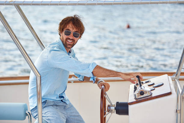 istock Man sailing on a boat and enjoy on sunny day at vacation. 1398870817
