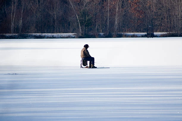 istock man ice fishing 139887224