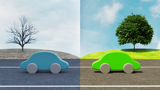 Concept image that shows a petrol car compared with an eletric car on a road. The electric car drives in sunlight while the petrol car drives on a clouded day.
