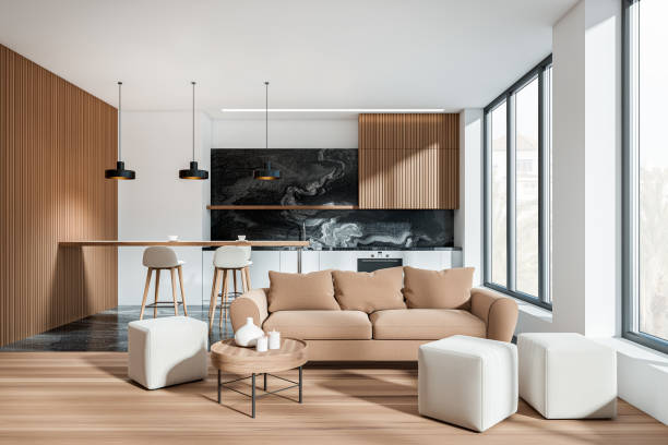 istock Stylish kitchen interior with cooking and lounge space with couch, window 1398876323