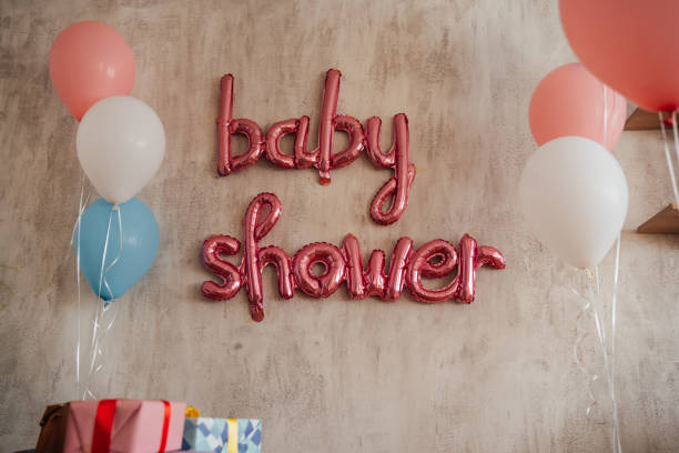 Wall decorated with pink balloons at a baby shower