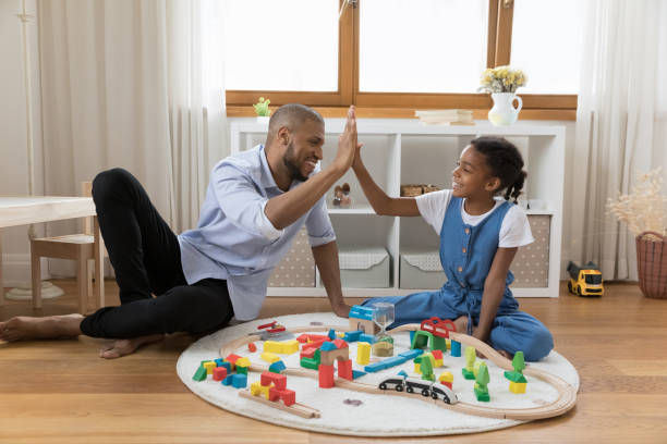 istock Cheery African dad little 8s daughter giving high five 1398877774