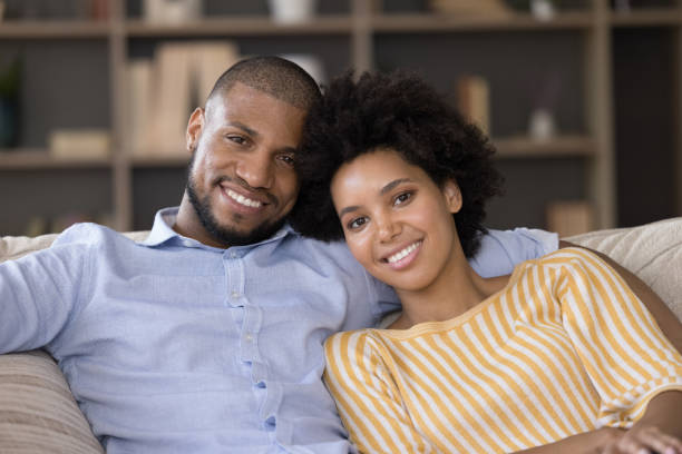 istock African couple in love relaxing on sofa look at camera 1398877851