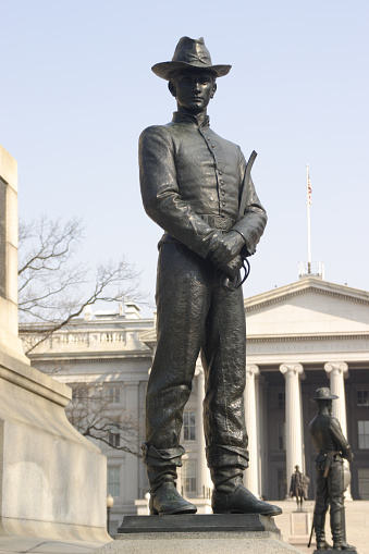 Statue of a cavalry officer standing guard found at the memorial to General Sherman, right next to the Whitehouse in Washington, DC.  The Treasury building is in the background.  