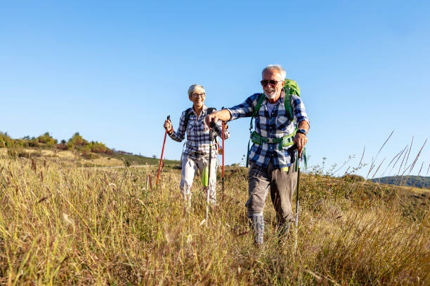 istock Active old woman and man walking at field and enjoy 1398879801