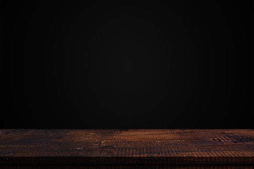 Wood table top on dark background