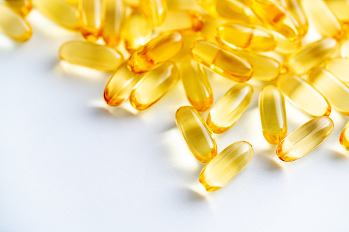 Close-up of a pills heap of fish oil Omega 3 on white background