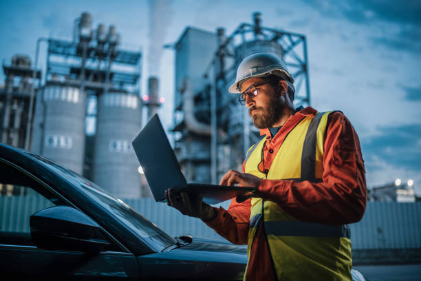 Engineer working in the oil and gas industry using laptop. stock photo