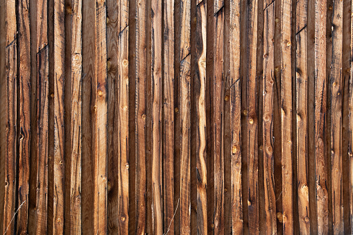 Old barn wood boards on south side of homestead barn building in northern Montana in the USA.