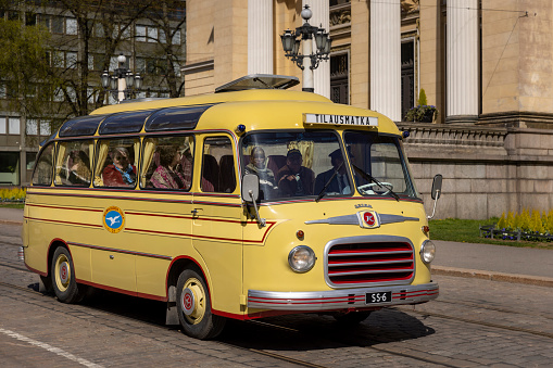 Helsinki, Finland - May 22nd 2022: A retro style tour bus is transporting tourists downtown Helsinki.