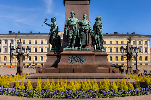 Helsinki, Finland - May 22nd 2022: Finnish Government building is part of historical archtitecture around Senate Square downtown Helsinki. Statue of Alexander II of Russia is located on square.
