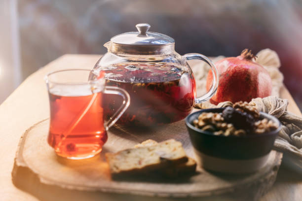 istock Morning breakfast with herbal tea, walnut, prune on wooden table. 1398887171