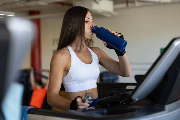 istock woman drinking water after training 1398887283