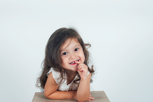 Little cute girl is laughing and looking at camera.