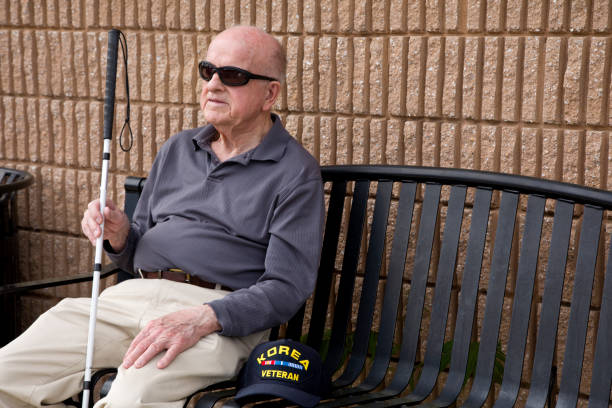 istock Blind Korean War veteran sitting on bench looking away 1398888649
