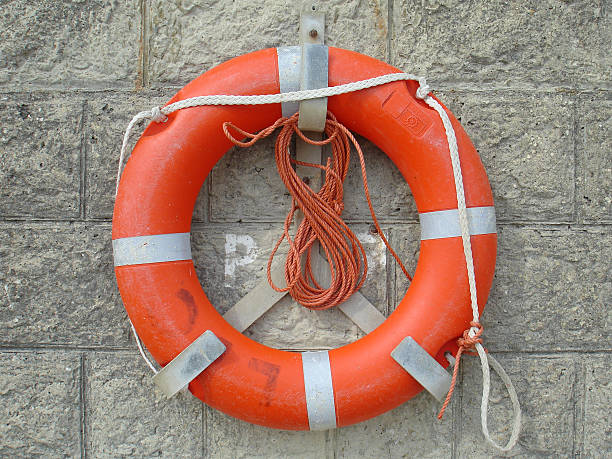 istock Life Preserver on stone wall. Orange rope. 139888969