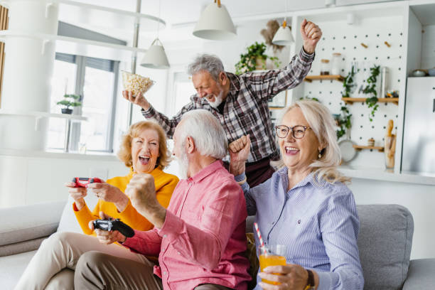 istock Cheerful senior playing video games online 1398889733