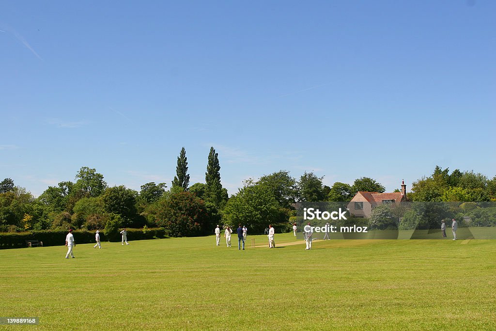 Cricket on The Village Green (with space for text) Two local cricket teams on a village green Sport of Cricket Stock Photo