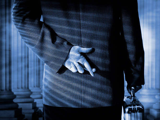 corporate fingers crossed business man in tension showing cross fingers hands behind back stock pictures, royalty-free photos & images