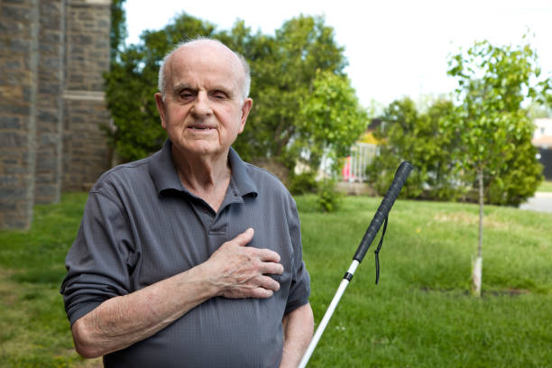 istock Blind man outdoors looking at camera hand over heart 1398894041