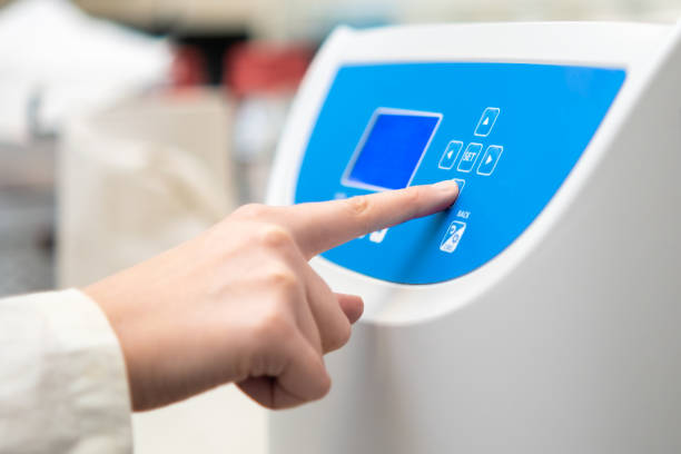 istock Woman sets parameters on the centrifuge for sample preparation. 1398894900