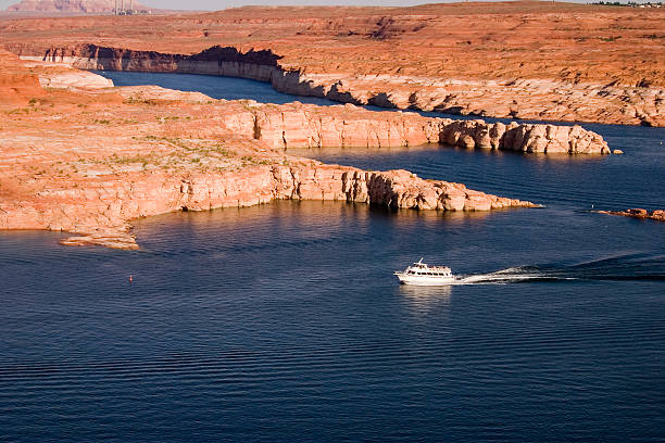 Boat on Lake A motor boat on the waters of Lake Powell. glen canyon stock pictures, royalty-free photos & images