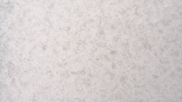 istock Salt crystals fall on glass on a bright white background. Salt bottom macro view. 1398896476