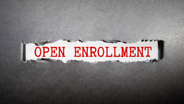 istock Torn paper with OPEN ENROLLMENT in opening background 1398896625