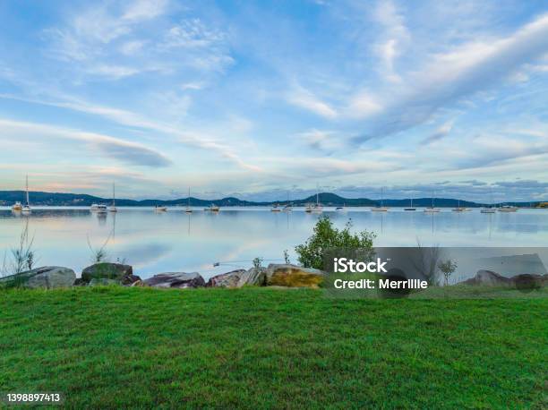 Reverse Sunset Pale Blues Waterscape With Boats And High Cloud Stock Photo - Download Image Now