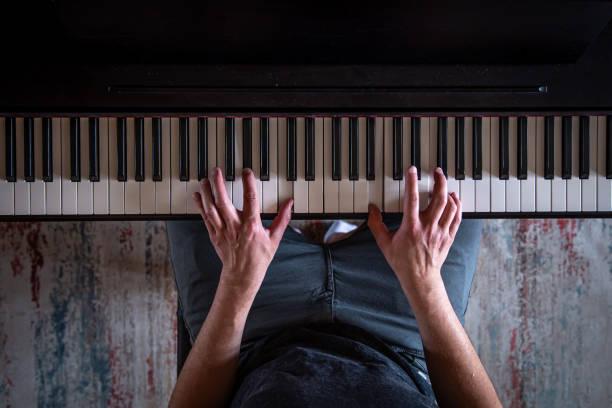 istock Male hands on the piano keys, top view. 1398897589
