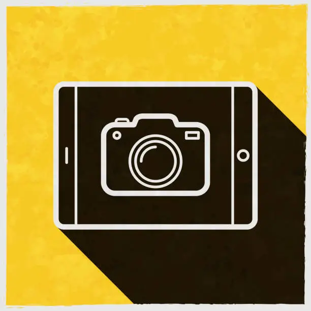 Vector illustration of Tablet PC with camera. Icon with long shadow on textured yellow background