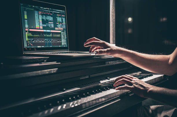 A man composer, producer, arranger, songwriter, musician hands arranging music. A man composer, producer, arranger, songwriter, musician hands arranging music on a computer at home studio, music production concept. composer stock pictures, royalty-free photos & images