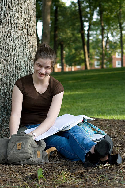 istock Beautiful brunette ivy league college student under tree 139890023