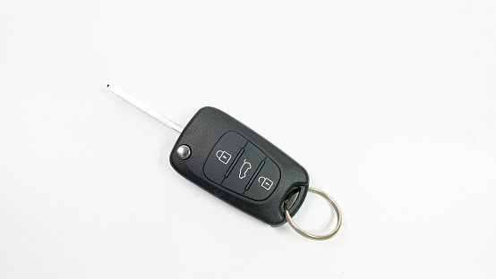 Modern car keys on white background