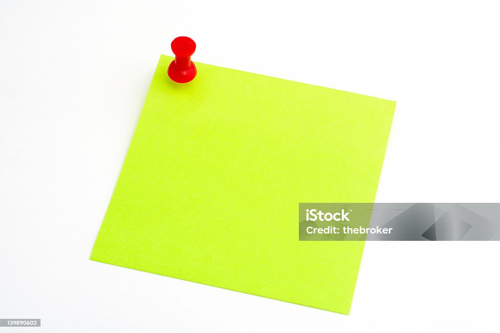 Isolated green paper with red pushnail on white background Adhesive Note Stock Photo