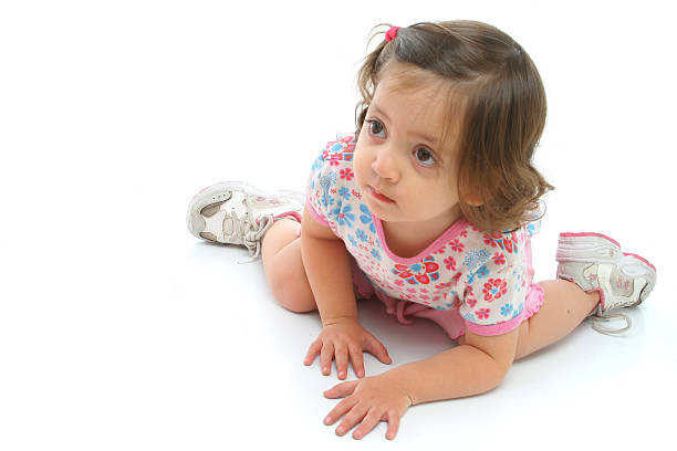Portrait of little girl in bright cotton dress looking at camera