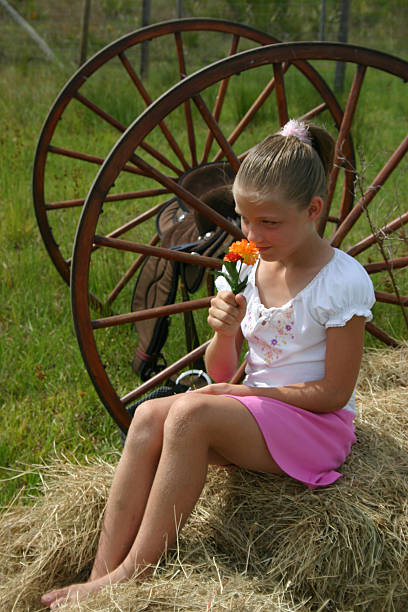 Girl Smelling Flowers stock photo