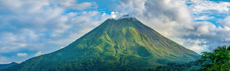 Arenal Vulcano, Fortuna, Costa Rica - May 22, 2022: Arenal is Costa Rica's best known vulcano. It's a stratovolcano – a large, symmetrical volcano that’s built upon layers of ash, rock and lava – and at 5,437 feet (1,657 meters), it stands high above the rest of the countryside. Arenal was active from 1968 to 2010 and was in that period the tenth most active vulcano on Earth.
